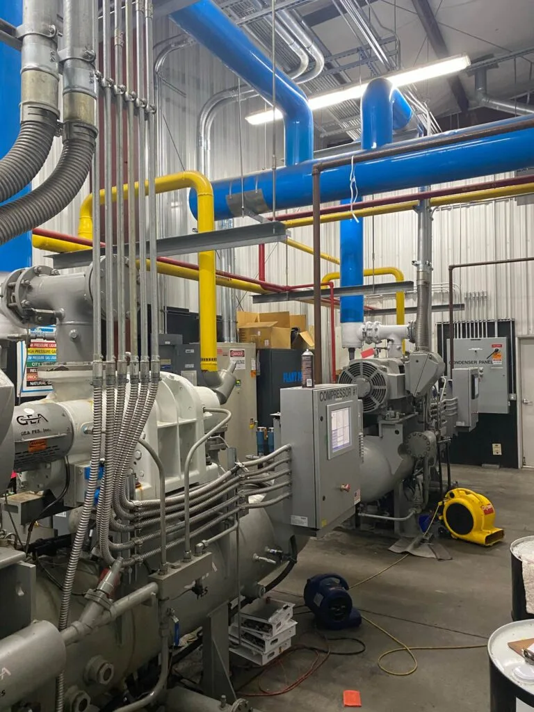 Industrial refrigeration screw compressors in a mechanical room Refrigeration screw compressors (2)